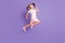 Full length profile side photo of pretty energetic small girl jump up air wear pink dress isolated on purple color