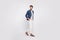 Full length profile side photo of pretty youth walk look wear blazer jacket pants trousers boat-shoes isolated over