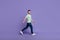 Full length profile side photo of satisfied man trendy clothes move empty space promenade good mood isolated on purple