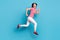 Full length profile side photo of young girl happy positive smile jump go run hurry sale isolated over blue color