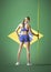 Full length rear view of javelin thrower standing over Brazilian flag