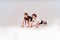 Full-length shot of active teenage boy and girl doing push-ups isolated over grey background, children engaged in sport.