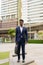 Full length shot of African businessman outdoors in city thinking