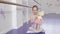 Full length shot of a lovely little ballerina waving to the camera playing with a doll