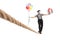 Full length shot of a mime walking on a rope and carrying balloons and a present