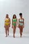 Full length shot of three proud diverse women with different body shapes in colorful underwear walking towards camera