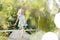 Full length of smiling blond girl running on pier at lakeshore