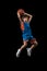 Full-length studio portrait of youn boy, teenager throwing a ball in a jump, basketball player in motion isolated over