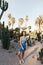 In full length of tender toung caucasian woman looking at camera stands near big cacti.