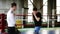 Full length of two young boxers on the ring in casual clothes work out punches with each other without gloves. Men train