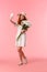Full-length vertical shot lovely, romantic and silly redhead woman enjoying beautiful spring day, holding bouquet