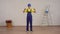 Full length video of a young construction foreman looking at the room under renovation, unfolding the construction tape