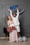 Full length view of a amused couple holding up inscription boy or girl during gender reveals party, over balloons.