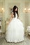 Full length view on beautiful woman posing in a wedding dress.