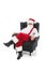 full length view of confident santa claus sitting in armchair and looking at camera