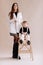 full length view of stylish young mother with adorable infant daughter. cute smiling child sitting on stepladder on