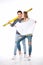 Full length view of young couple standing together with blueprint and level tool