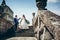 Full-length wedding portrait of the adorable newlywed couple going down the old castle strais. The groom is helping his