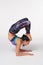 Full length Woman practicing yoga Vrschikasana, Scorpion pose