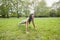 Full length of young fit woman performing pushups at park