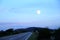 Full moon above road and rural landscape in the Croatian Island of Pag