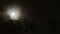 Full moon behind clouds at night. 4K UHD