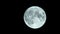 Full moon in the black sky.