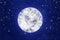 Full moon on blue night sky with stars