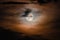 Full moon on a cloudy night. Natural colored clouds around the Moon