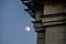 Full moon during the day on dusk next to a building roof. Beautiful wallpaper landscape.