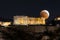 Full moon eclipse over the Parthenon Temple of the Acropolis of Athens, Greece