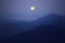 Full moon evening over mysterious range