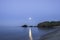 Full moon and moonbeam between the rocks on cala Presili, Menorca, Spain.