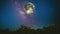 Full moon orbiting through the fantastic night sky above tree tops