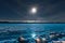 Full moon over frozen Lake Laberge Yukon Canada