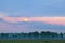 Full moon over meadows at sunrise