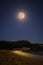 Full moon over the Spanish beach, near the small holiday village