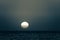 Full moon passing by over sky over island sea time lapse