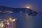 Full moon rise above Budva old city, Saint Nicholas island and Adriatic littoral, night cityscape, Montenegro, Europe. Famous