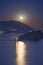 Full moon rise above Budva Riviera, Saint Nicholas island and Adriatic littoral, night cityscape, Montenegro, Europe. Famous