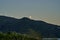 Full moon rising over the beautiful landscape of a mountain ridge