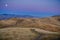 Full moon rising over golden hills, as seen from Mission Peak, San Francisco bay area, California