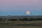 A full moon rising over a North Dakota grain field