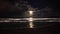 Full moon rising over sea waves. Dramatic sunset over beach video