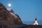 Full moon rising over Vik church in Iceland