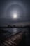 Full moon`s halo above the frozen lake