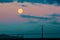 The full moon setting behind the Golden Gate Bridge and the fog just before sunrise.