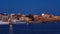 Full moon setting over Chania`s Old Venetian Harbour. Night view of piers, boats and Maritime museum of Crete and houses