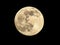 Full moon showing craters isolated on black background in night sky