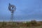 Full moon at windmill and cosmos flowers before sunrise